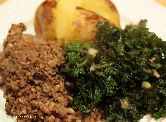 Vegetarian haggis served with flower sprouts and a baked potato